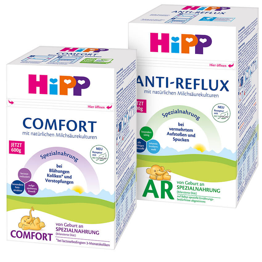 Two boxes of baby products, one labeled "COMFORT" and the other "ANTI-REFLUX," are displayed with a cartoon elephant illustration and German text.
